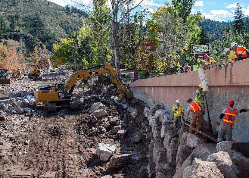 Army and Air National Guard units pour concrete underneath a bridge where water from the floods washed away the support weeks before.  The area in the photo to the left, where the excavator is sitting, is where the river normally runs, but it is being diverted in order to completebridge construction, then the river will be routed back to it's original location.  The 219th RED HORSE Unit from the Montana Air National Guard is the main crew at this site along Route 36.  National guard units from Colorado, Utah, Kansas and Montana participate in reconstruction the Colorado State Route 36 after recent floods devistate the area.  Army and Air National Guard units provide civil engineer and Red Horse units to repair the roads and provide a 24-foot wide passable road before December 1st, 2013.  Currently they are ahead of schedule.  National Guard photo/Senior Master Sgt. John Rohrer.