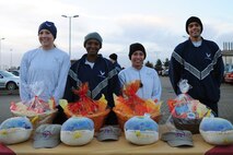 Team Mildenhall members receive their prizes after the yearly Turkey Trot wing run Nov. 20, 2013, on RAF Mildenhall, England. The event, held prior to Thanksgiving, allowed the first 150 runners who completed the race a chance to win a meal-in-a-basket, which included a turkey, a box of instant mashed potatoes and a can of cranberry sauce. (U.S. Air Force photo by Senior Airman Kate Maurer/Released)