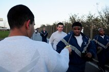 Team Mildenhall members receive tickets at the finish line of the yearly Turkey Trot wing run Nov. 20, 2013, on RAF Mildenhall, England. The event, held prior to Thanksgiving, allowed the first 150 runners who completed the race a chance to win a meal-in-a-basket, which included a turkey, a box of instant mashed potatoes and a can of cranberry sauce. (U.S. Air Force photo by Senior Airman Kate Maurer/Released)