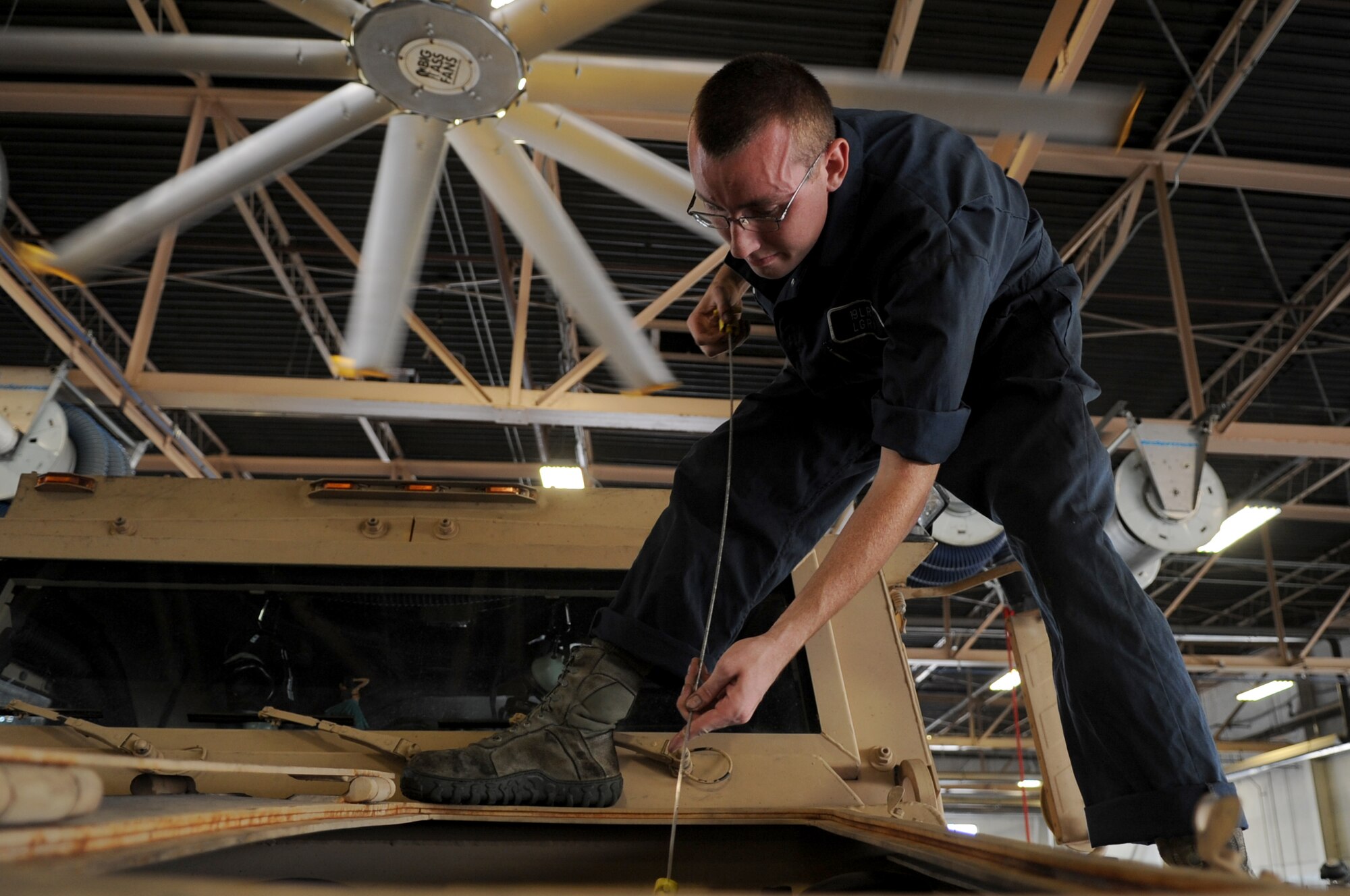 Airman 1st Class Ethan Troutman, a 19th Logistics Readiness Squadron vehicle maintenance apprentice, performs a routine maintenance check on a vehicle Sept. 11, 2013, at Little Rock Air Force Base, Ark. Vehicle management’s mission is to provide safe and serviceable vehicles to the base fleet. (U.S. Air Force photo by Staff Sgt. Caleb Pierce)
