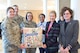 Fisher House Foundation Board of Trustees Vice Chairmen Audrey Fisher and Nancy Edelman present a Delaware pillow to the staff at the Fisher House for Families of the Fallen Oct. 28, 2011. (U.S. Air Force photo/Adrian R. Rowan)