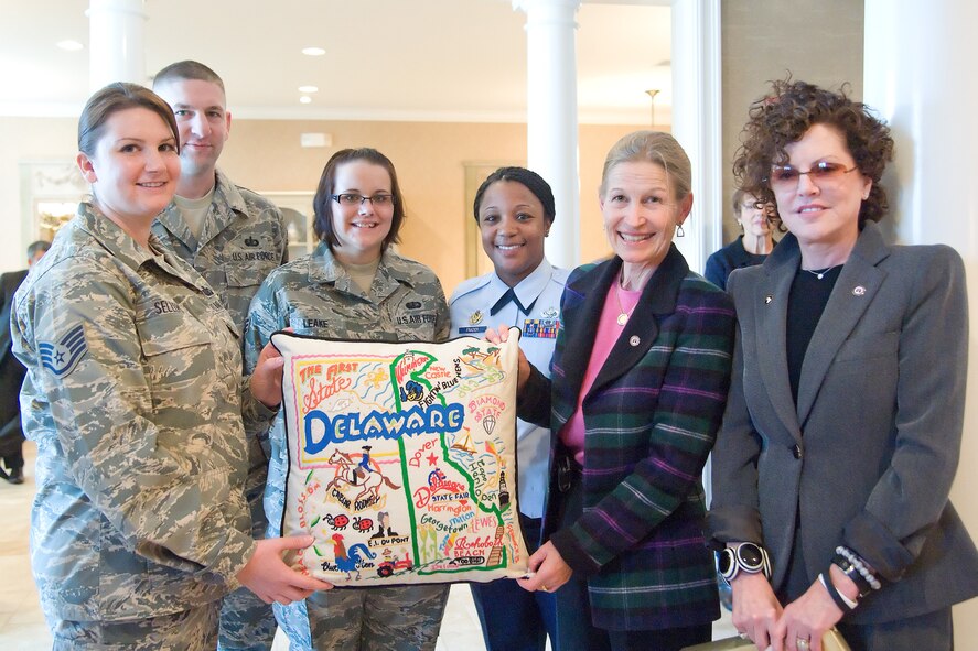 Fisher House Foundation Board of Trustees Vice Chairmen Audrey Fisher and Nancy Edelman present a Delaware pillow to the staff at the Fisher House for Families of the Fallen Oct. 28, 2011. (U.S. Air Force photo/Adrian R. Rowan)
