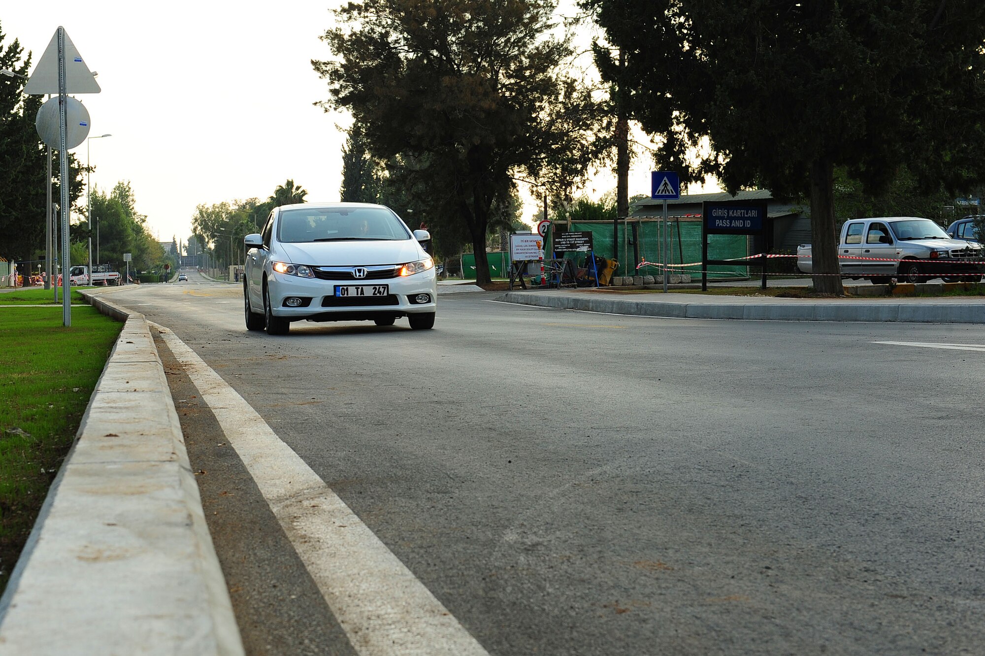 A car drives toward the roundabout on E Street Nov. 21, 2013, at Incirlik Air Base, Turkey.  After being under construction for more than three months E Street has been finished ten days ahead of the construction schedule.  There are sidewalk construction plans for a path leading to the ATM machine in the next couple of days. (U.S. Air Force photo by Airman 1st Class Nicole Sikorski/Released)