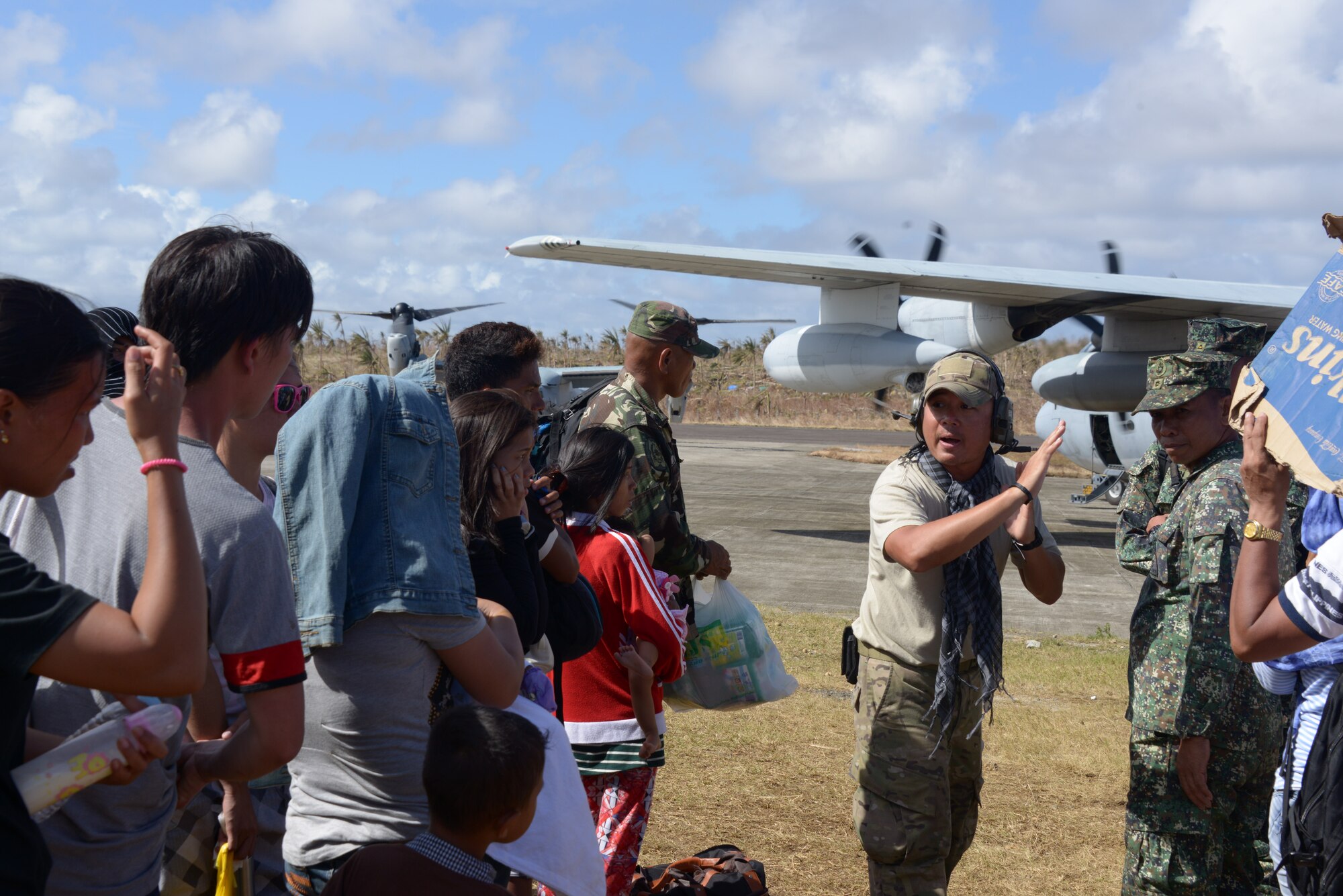 Staff Sgt. Antonio Garcia, 353rd Special Operations Group, organizes passengers waiting for transport before they board an aircraft at Guiuan Airport, Republic of the Philippines Nov. 17.  Air Force Special Operations Command Airmen are deployed in support of Operation Damayan, in the aftermath of Typhoon Haiyan. Garcia, assigned to the 353rd SOG as a vehicle maintainer, served as a translator during this mission. (U.S. Air Force photo by Tech. Sgt. Kristine Dreyer)