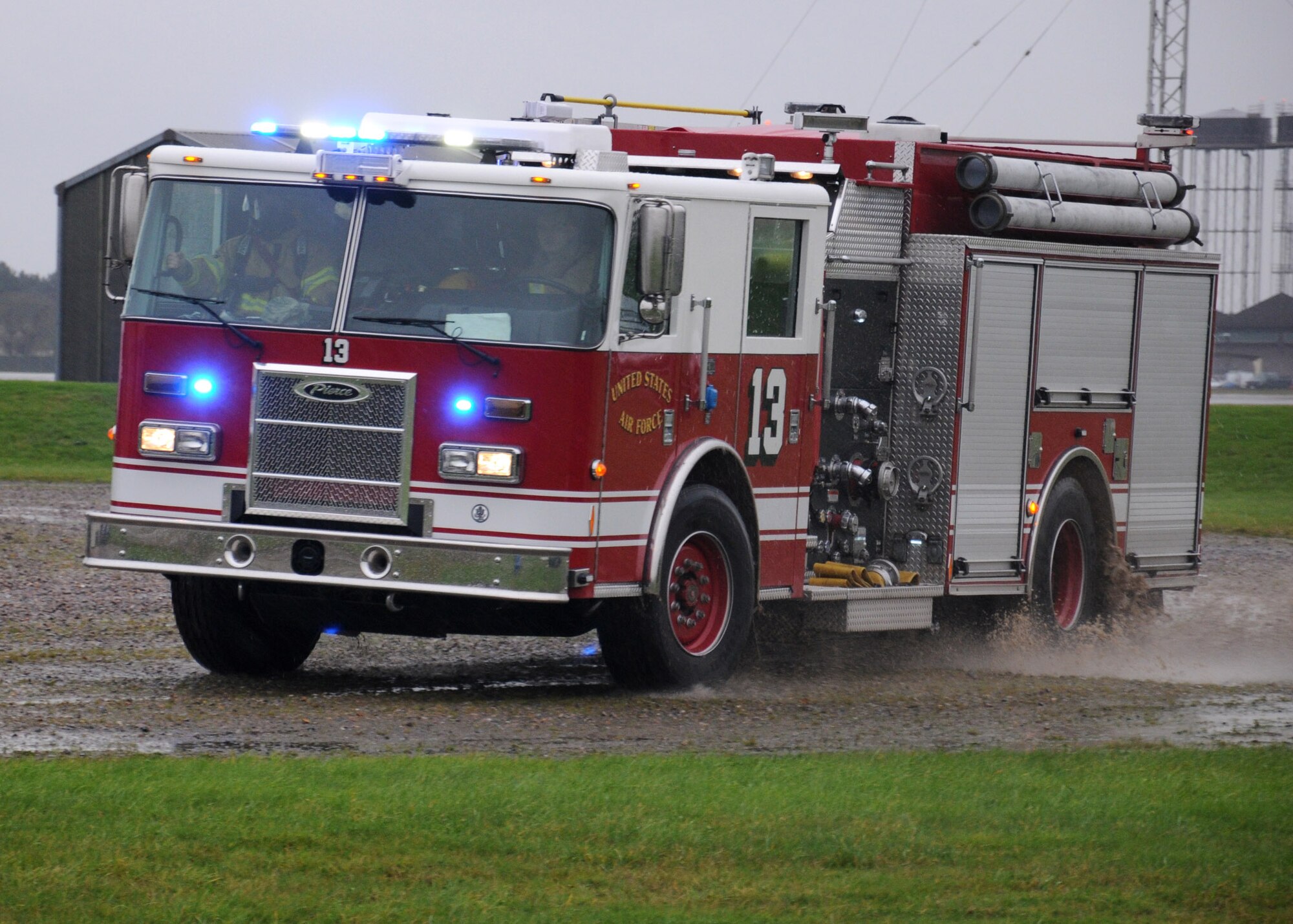 Members of the 100th Civil Engineer Squadron Fire Department respond during a training exercise Nov. 20, 2013, at the fire training facility on RAF Mildenhall, England. During the training, firefighters used a PyroLance. The tool’s ultra high pressure (approximately 2,000 pounds per square inch) creates smaller water droplets with a minimal amount of water to produce a greater capability of absorbing heat from a fire. (U.S. Air Force photo by Gina Randall/Released)
