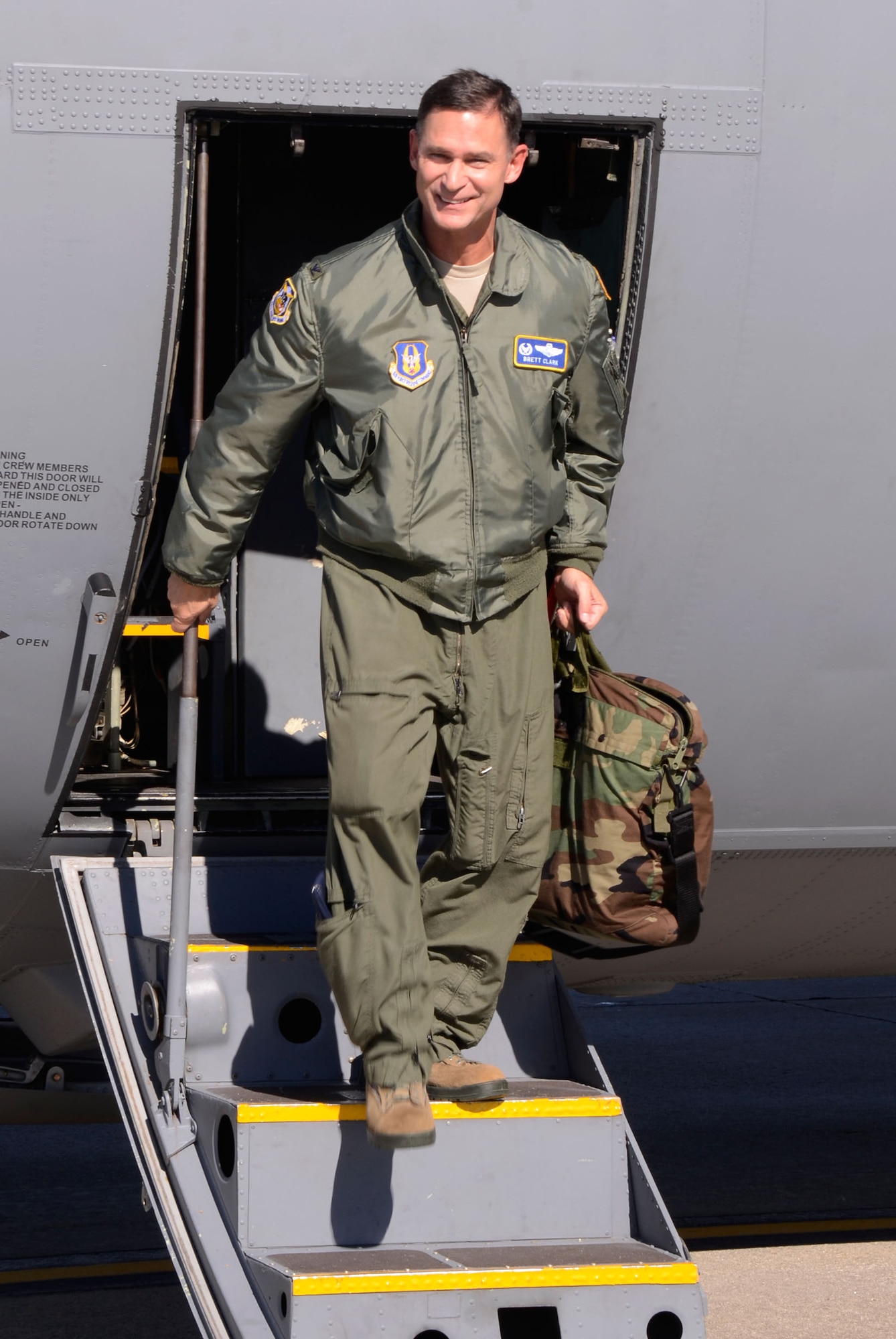 Col. Brett J. Clark, newly assigned 94th Airlift Wing commander, exits a C-130 Hercules after completing his first flight at Dobbins Air Reserve Base, Ga., Nov. 19. Clark is responsible for over 2,500 wing personnel, and the entire installation comprised of 13 tenant units, including 22nd Air Force, Air Force Plant 6 and Lockheed-Martin, Georgia Army and Air National Guard and the Army, Navy and Marine Corps Reserves. (U.S. Air Force photo/Don Peek)