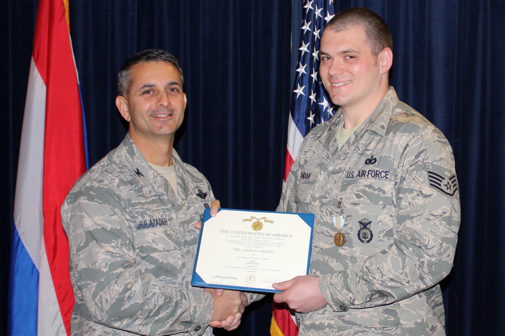 U.S. Air Force Col. David J. Julazadeh, 52nd Fighter Wing commander,
presents Staff Sgt. Nathan P. Londak, a security forces Airman stationed at
Volkel Air Base, The Netherlands, an Airman's Medal on Nov. 15. This medal is
given to service members who distinguish themselves with heroic actions,
usually at the voluntary risk of their lives, but without involving combat.
Londak received this medal for his heroic actions in stopping an armed
robbery in March 2011. (U.S. Air Force courtesy photo/released)
