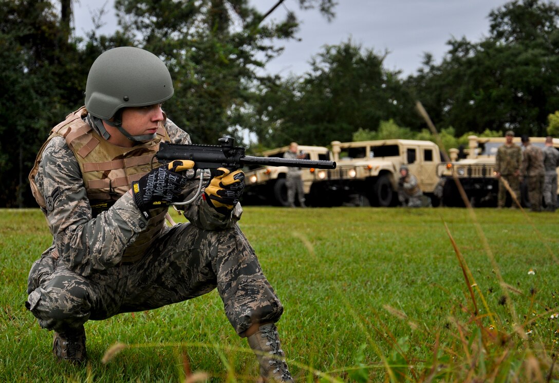 Airman 1st Class Jeffery Ball, 6th Logistics Readiness Squadron vehicle operator, secures the area during combat convoy training, Nov. 2, 2013 at MacDill Air Force Base, Fla. The training is designed to train transportation Airmen in basic combat skills required to integrate with joint forces in hostile convoy operations. (U.S. Air Force photo by 2nd Lt. Patrick Gargan /Released)  