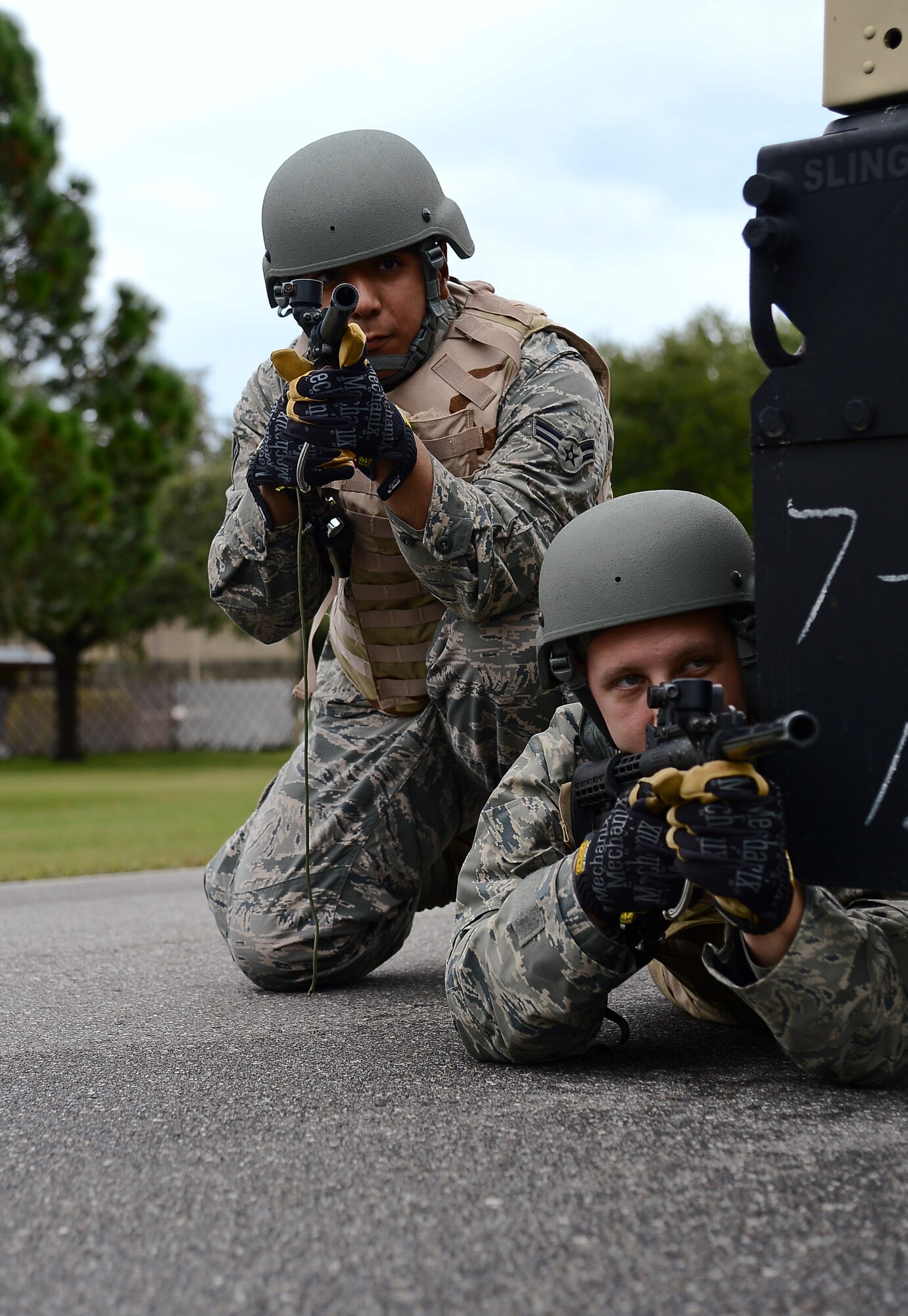 Airmen 1st Class Michael Garcia and Jonathan Hodges, 6th Logistics Readiness Squadron vehicle operators, secure the area during combat convoy training, Nov. 2, 2013 at MacDill Air Force Base, Fla. The training introduced a diversified set of “mock” threat scenarios to include: vehicle-borne improvised explosive devices detection, small arms fire ambushes, vehicle recovery procedures, and proper vehicle formation attack and assessment roles. (U.S. Air Force photo by Senior Airman Melanie Bulow-Gonterman/Released)   