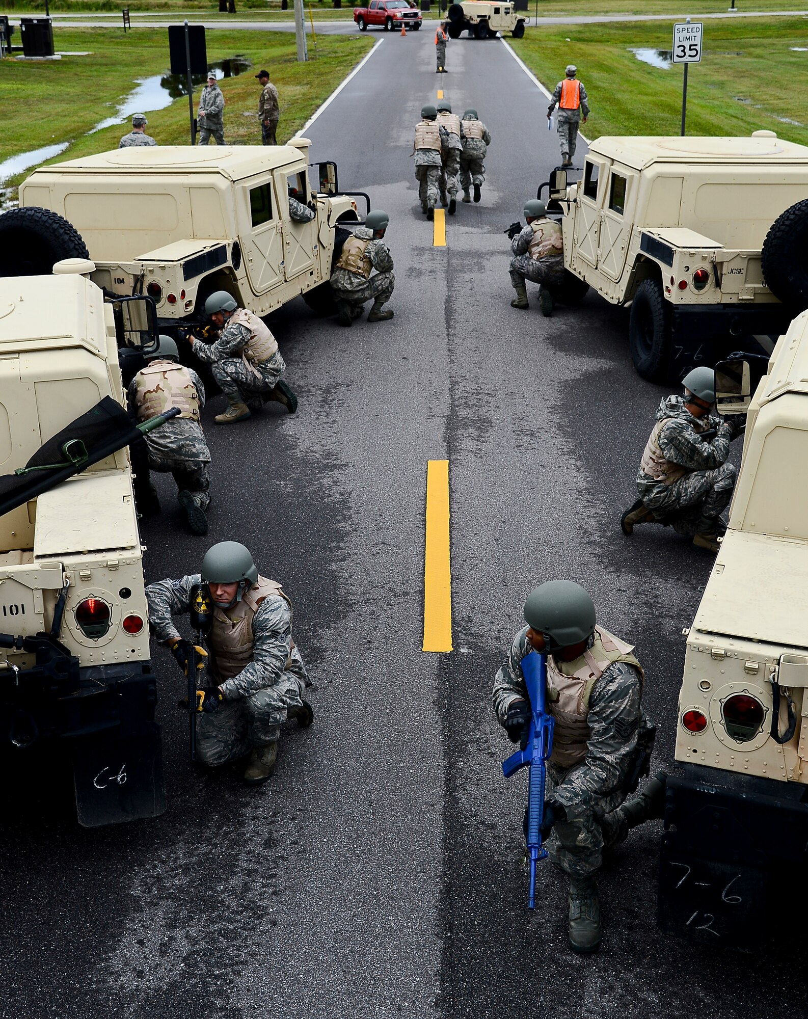 Vehicle operator Airmen from the 6th Logistics Readiness Squadron provide 360-security during a simulated medical evacuation, Nov. 2, 2013 at MacDill Air Force Base, Fla. The training simulated administrating self-aid buddy care (SABC), calling in “9-line medical evacuations,” and helicopter evacuations procedures. (U.S. Air Force photo by Senior Airman Melanie Bulow-Gonterman/Released)  