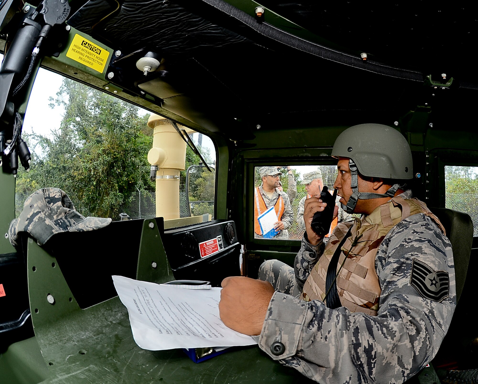 Tech. Sgt. Armando Gomez, 6th Logistics Readiness Squadron records and licensing, communicates with a convoy team during combat convoy training, Nov. 2, 2013 at MacDill Air Force Base, Fla. The training introduced a diversified set of “mock” threat scenarios to include: vehicle-borne improvised explosive devices detection, small arms fire ambushes, vehicle recovery procedures, and proper vehicle formation attack and assessment roles.  (U.S. Air Force photo by Senior Airman Melanie Bulow-Gonterman/Released)     