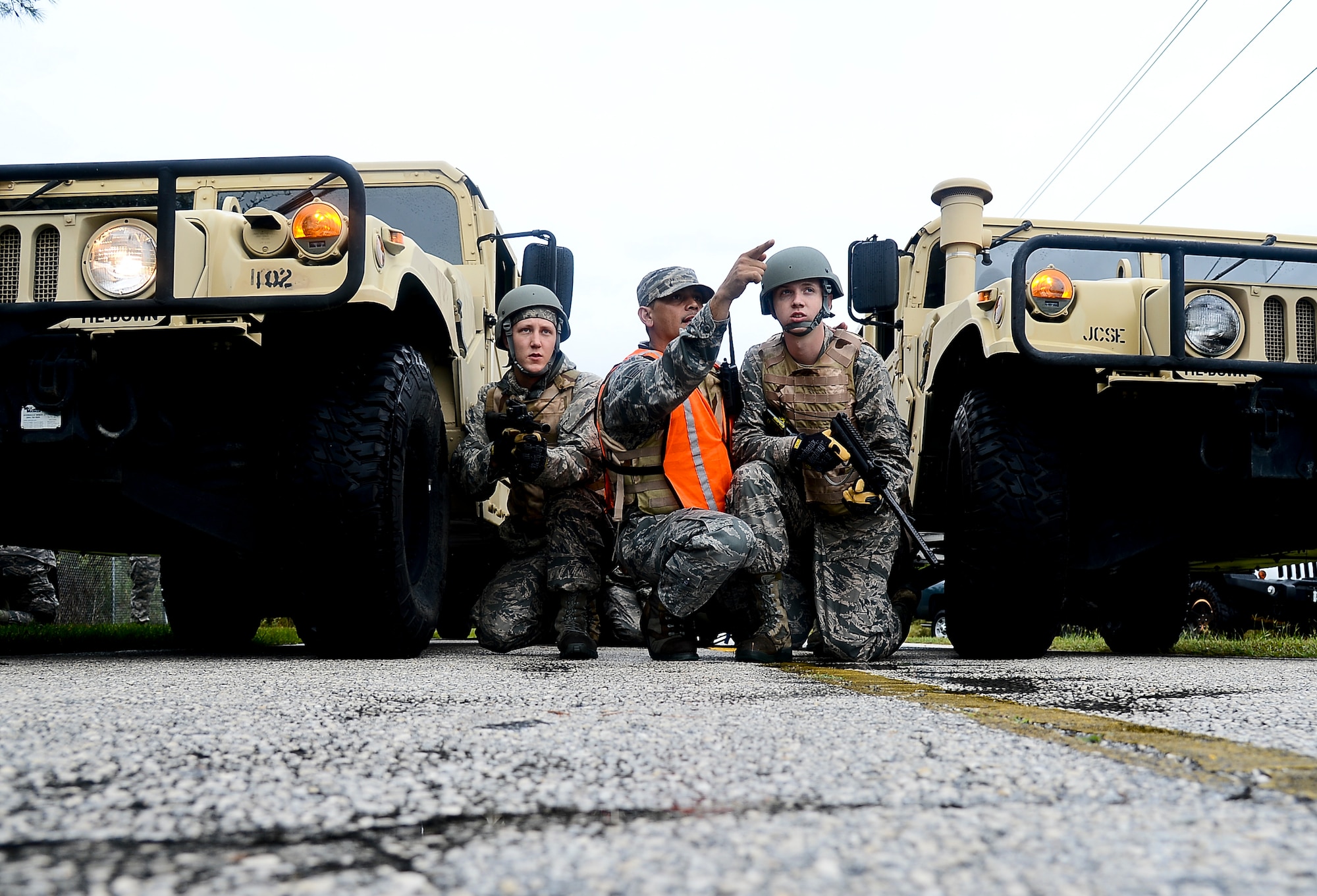 Airmen 1st Class Jonathan Hodges and Jeffery Ball, 6th Logistics Readiness Squadron vehicle operators, receive instruction from Tech. Sgt Gany Gamboa, 6th LRS NCO in charge of training and validation office, during convoy training, Nov. 2, 2013 at MacDill Air Force Base, Fla. The training introduced a diversified set of “mock” threat scenarios to include: vehicle-borne improvised explosive devices detection, small arms fire ambushes, vehicle recovery procedures, and proper vehicle formation attack and assessment roles. (U.S. Air Force photo by Senior Airman Melanie Bulow-Gonterman/Released)   