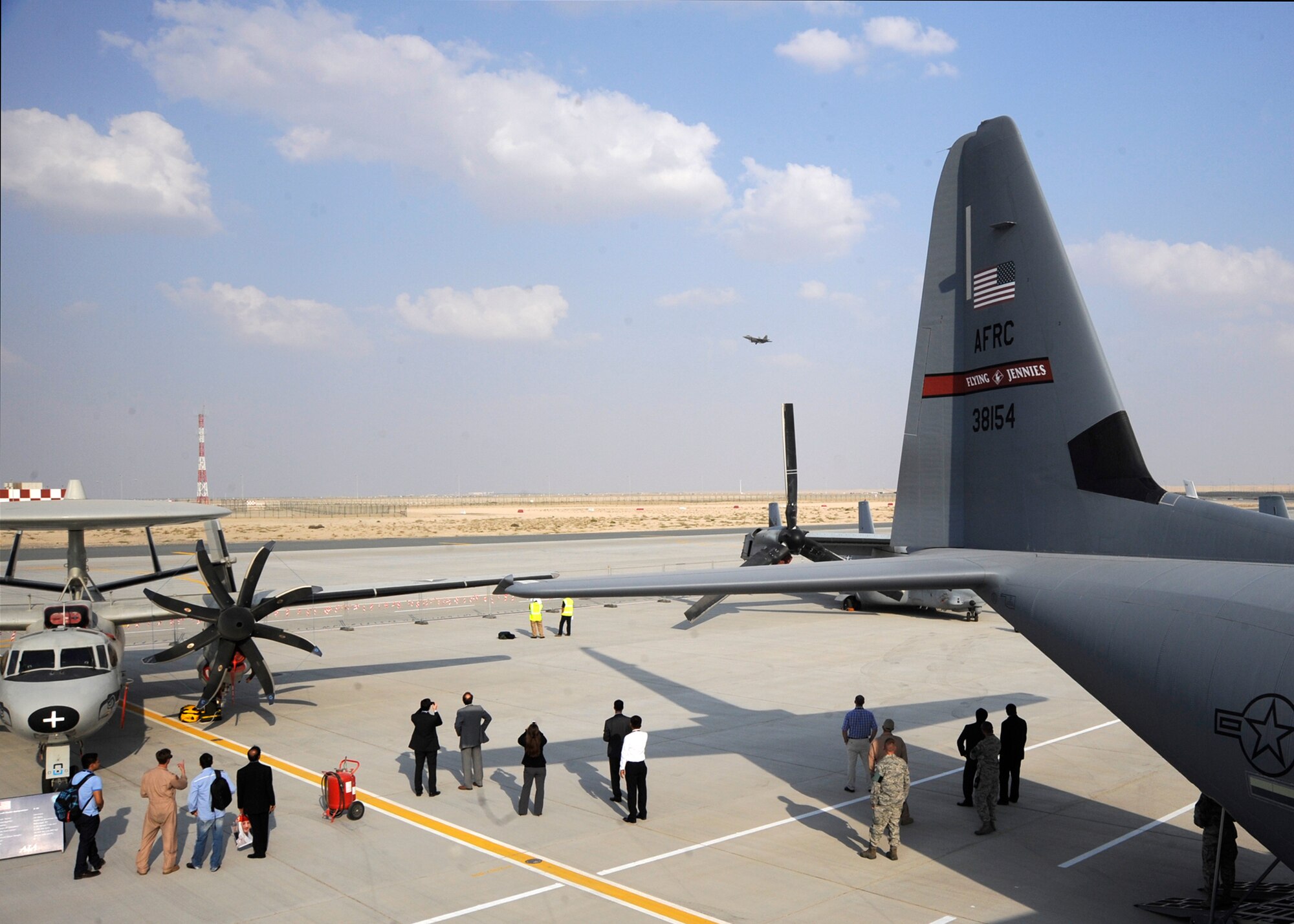 Spectators look on as a B-1B Lancer flies over the 2013 Dubai Airshow at the Dubai World Central airport in Jebel Ali, United Arab Emirates, Nov. 20, 2013. The Lancer is assigned to the 9th Expeditionary Bomb Squadron deployed from Dyess Air Force Base, Texas. The United States participates in the Dubai Air Show to demonstrate a commitment to regional security, to demonstrate the flexibility of airpower, and to strengthen military-to-military relationships with regional partners.  (U.S. Air Force photo/Senior Airman Bahja J. Jones)