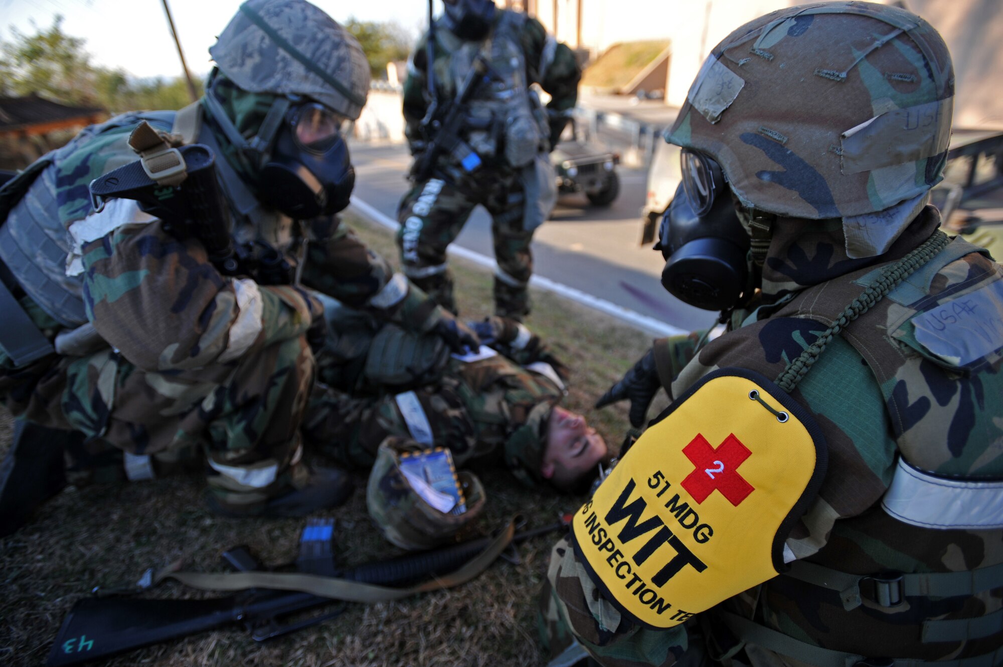 A member of the 51st Medical Group’s wing inspection team quizzes a member of the 51st Security Forces Squadron about self aid buddy care procedures after the last ground attack of Operational Readiness Exercise Beverly Bulldog 14-01 at Osan Air Base, Republic of Korea, Nov. 21, 2013. Scenarios like this give Airmen a chance to hone wartime skills in a safe and structured environment in preparation for real-world contingencies. (U.S. Air Force photo/Senior Airman Siuta B. Ika)