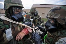 Senior Airman Myriam Rodriquez-Ojeda wraps the a wound on the arm of Airman 1st Class Dillon Treichler during a mass casualty exercise scenario during Operational Readiness Exercise Beverly Bulldog 14-01 at Osan Air Base, Republic of Korea, Nov. 21, 2013. Rodriquez-Ojeda and Treichler are both members of the 51st Logistics Readiness Squadron. (U.S. Air Force photo/Senior Airman Siuta B. Ika)