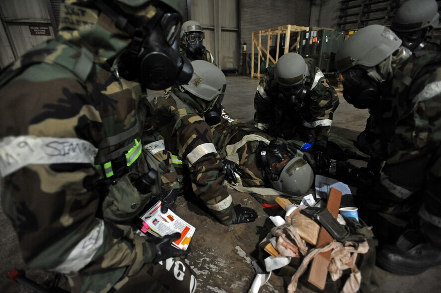 Members of the 51st Logistics Readiness Squadron tend to the wounds of a simulated victim during a mass casualty exercise scenario during Operational Readiness Exercise Beverly Bulldog 14-01 at Osan Air Base, Republic of Korea, Nov. 21, 2013. Mass casualty situations in a real-world operation could require Airmen to call on their knowledge of not only care in a conventional setting, but also of care under fire. (U.S. Air Force photo/Senior Airman Siuta B. Ika)