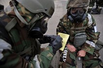 Tech. Sgt. Shaun Mitchell writes which simulated nerve agent antidote was given to Senior Airman Joshua Wachtel during a mass casualty exercise scenario during Operational Readiness Exercise Beverly Bulldog 14-01 at Osan Air Base, Republic of Korea, Nov. 21, 2013. Mitchell and Wachtel are both members of the 51st Logistics Readiness Squadron. (U.S. Air Force photo/Senior Airman Siuta B. Ika)