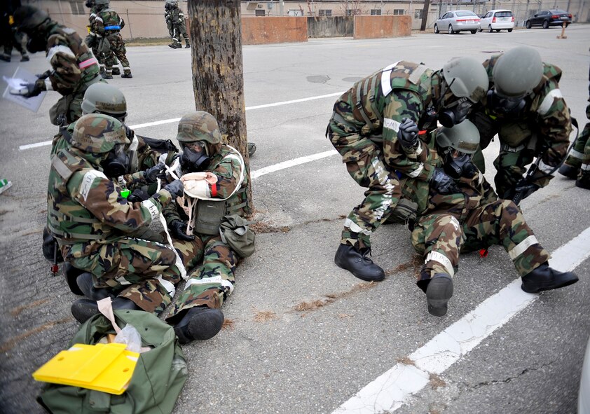 First responders tend to the wounds of a role players during a mass casualty exercise scenario during Operational Readiness Exercise Beverly Bulldog 14-01 at Osan Air Base, Republic of Korea, Nov. 21,2013. Scenarios like these give Airmen a chance to hone wartime skills in a safe and structured environment in preparation for real-world contingencies. (U.S. Air Force photo/Staff Sgt. Emerson Nuñez)