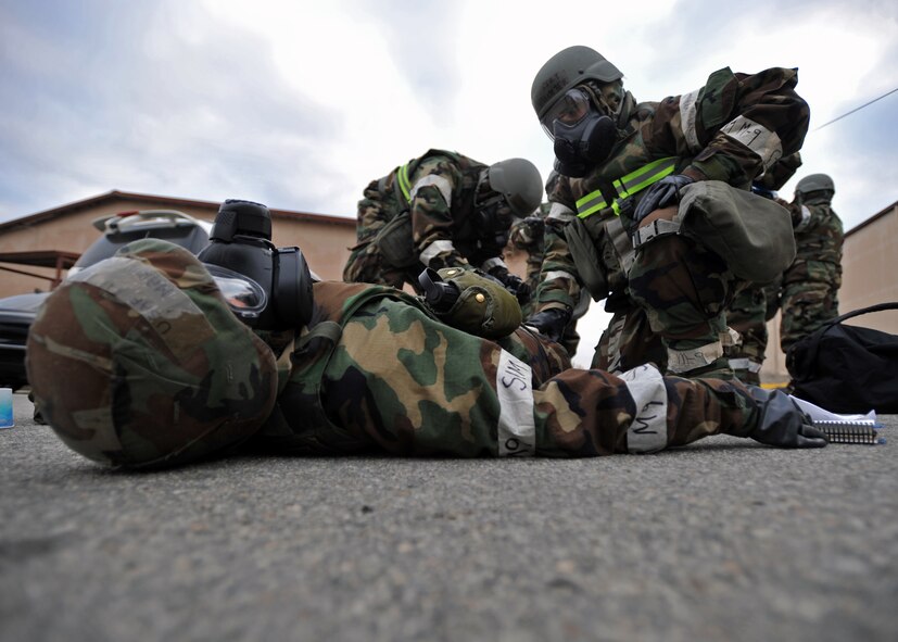 Members of the 51st Logistics Readiness Squadron tend to the wounds of a simulated victim during a mass casualty exercise scenario during Operational Readiness Exercise Beverly Bulldog 14-01 at Osan Air Base, Republic of Korea, Nov. 21, 2013. Scenarios like this gives Airmen a chance to hone wartime skills in a safe and structured environment in preparation for real-world contingencies. (U.S. Air Force photo/Senior Airman Siuta B. Ika)