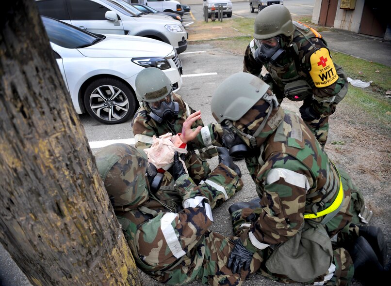 First responders tend to the wounds of a role player during a mass casualty exercise scenario during Operational Readiness Exercise Beverly Bulldog 14-01 at Osan Air Base, Republic of Korea, Nov. 21,2013. Throughout the week, Airmen will work together through several different scenarios that will test their ability to defend the base and conduct daily operations during a heightened state of readiness. (U.S. Air Force photo/Staff Sgt. Emerson Nuñez)