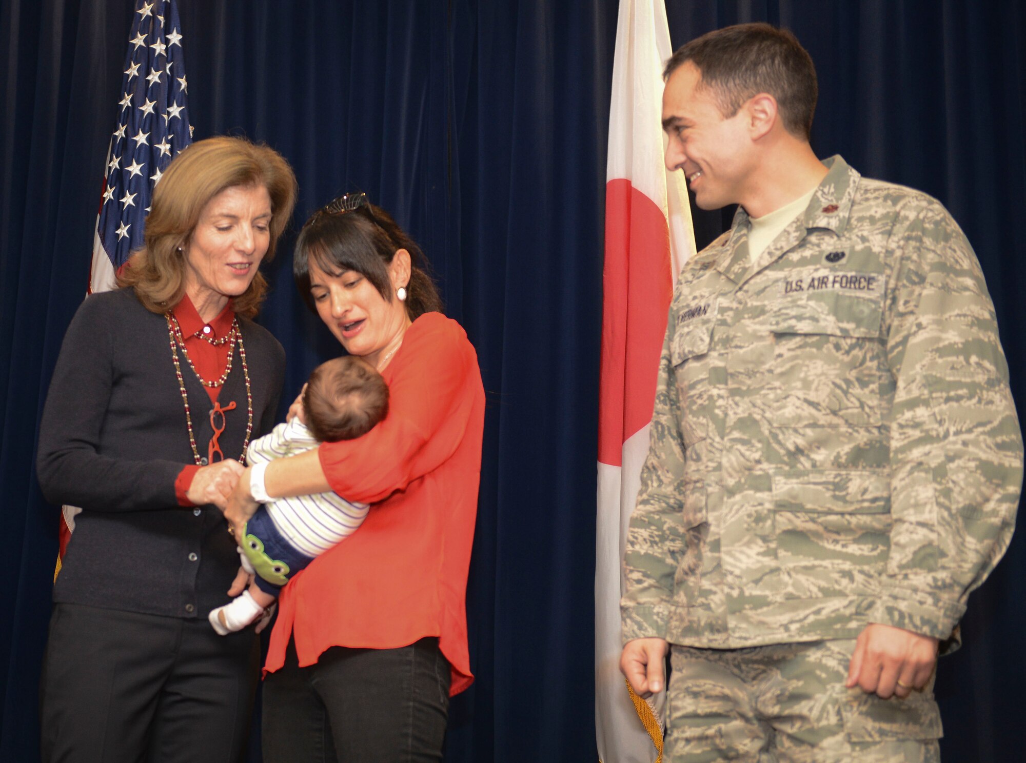 Maj. Justin Silverman and his wife show U.S. Ambassador Caroline Kennedy their baby at Yokota Air Base, Japan, Nov. 21, 2013.  Kennedy met with service members and families after she thanked them for their service. (U.S. Air Force photo by Airman 1st Class Meagan Schutter/Released)