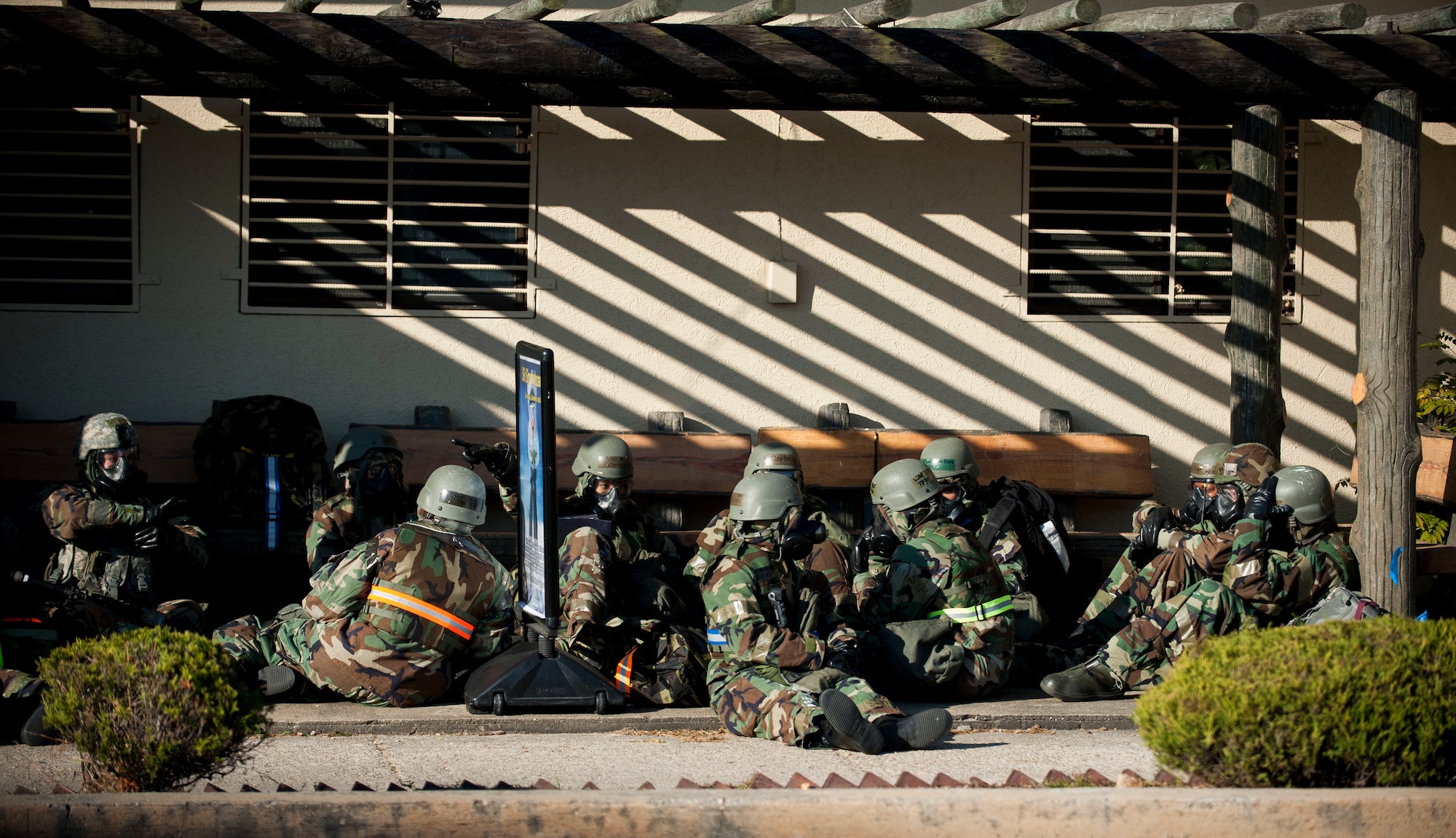 Airmen take cover from a simulated mortar attack during exercise Beverly Bulldog 14-01 at Kunsan Air Base, Republic of Korea, Nov. 21, 2013. The base tested its ability to survive and continue its primary missions under simulated hostile field conditions. The Wolf Pack, along with other 7th Air Force units, continued performing its operational and tactical wartime missions during the peninsula-wide exercise. (U.S. Air Force photo by Senior Airman Clayton Lenhardt/Released)