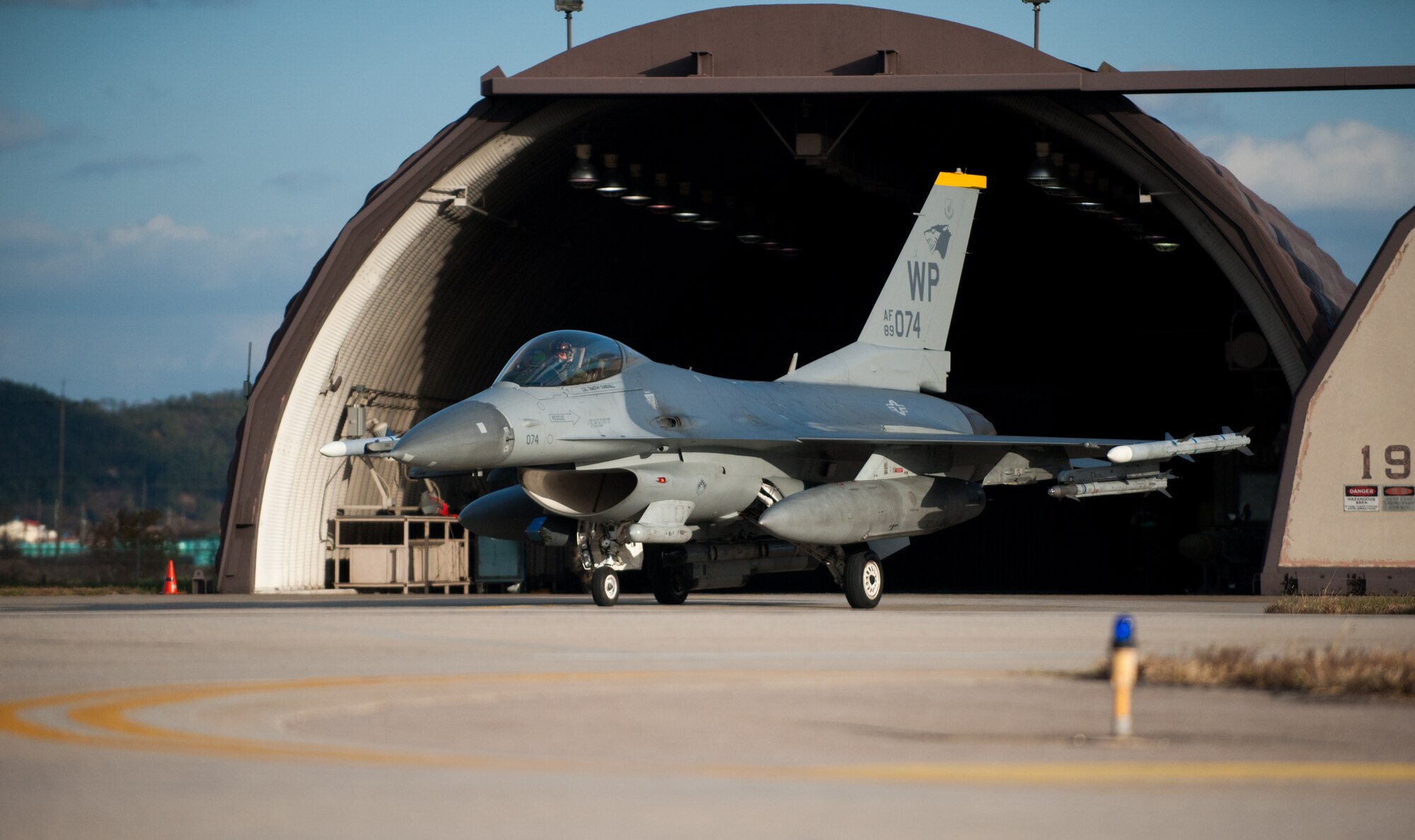An 80th Fighter Squadron F-16 Fighting Falcon taxis toward the runway for an exercise sortie at Kunsan Air Base, Republic of Korea, Nov. 20, 2013. Kunsan’s pilots and maintainers continued to launch F-16 Fighting Falcons during a simulated chemical environment. The base tested its ability to generate aircraft under simulated hostile field conditions. The Wolf Pack, along with other 7th Air Force units, continued performing its operational and tactical wartime missions during the peninsula-wide exercise Beverly Bulldog 14-01. (U.S. Air Force photo by Senior Airman Armando A. Schwier-Morales)