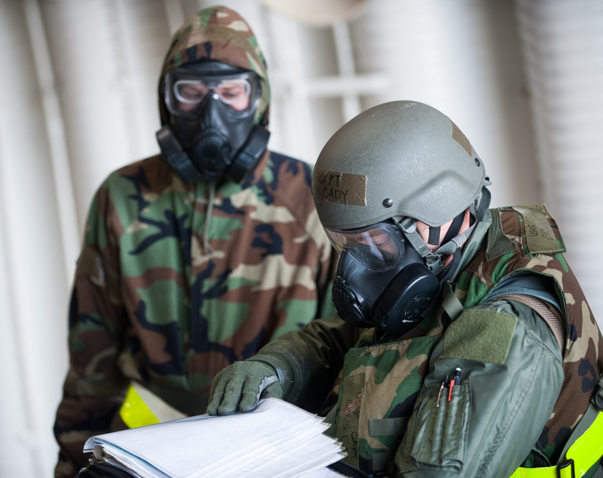 Capt. Christopher Cady, 80th Fighter Squadron pilot, reviews his F-16 Fighting Falcon’s status prior to taking command during an exercise at Kunsan Air Base, Republic of Korea, Nov. 20, 2013. Kunsan’s pilots and maintainers continued to launch F-16 Fighting Falcons during a simulated chemical environment. The base tested its ability to generate aircraft under simulated hostile field conditions. The Wolf Pack, along with other 7th Air Force units, continued performing its operational and tactical wartime missions during the peninsula-wide exercise Beverly Bulldog 14-01. (U.S. Air Force photo by Senior Airman Armando A. Schwier-Morales)