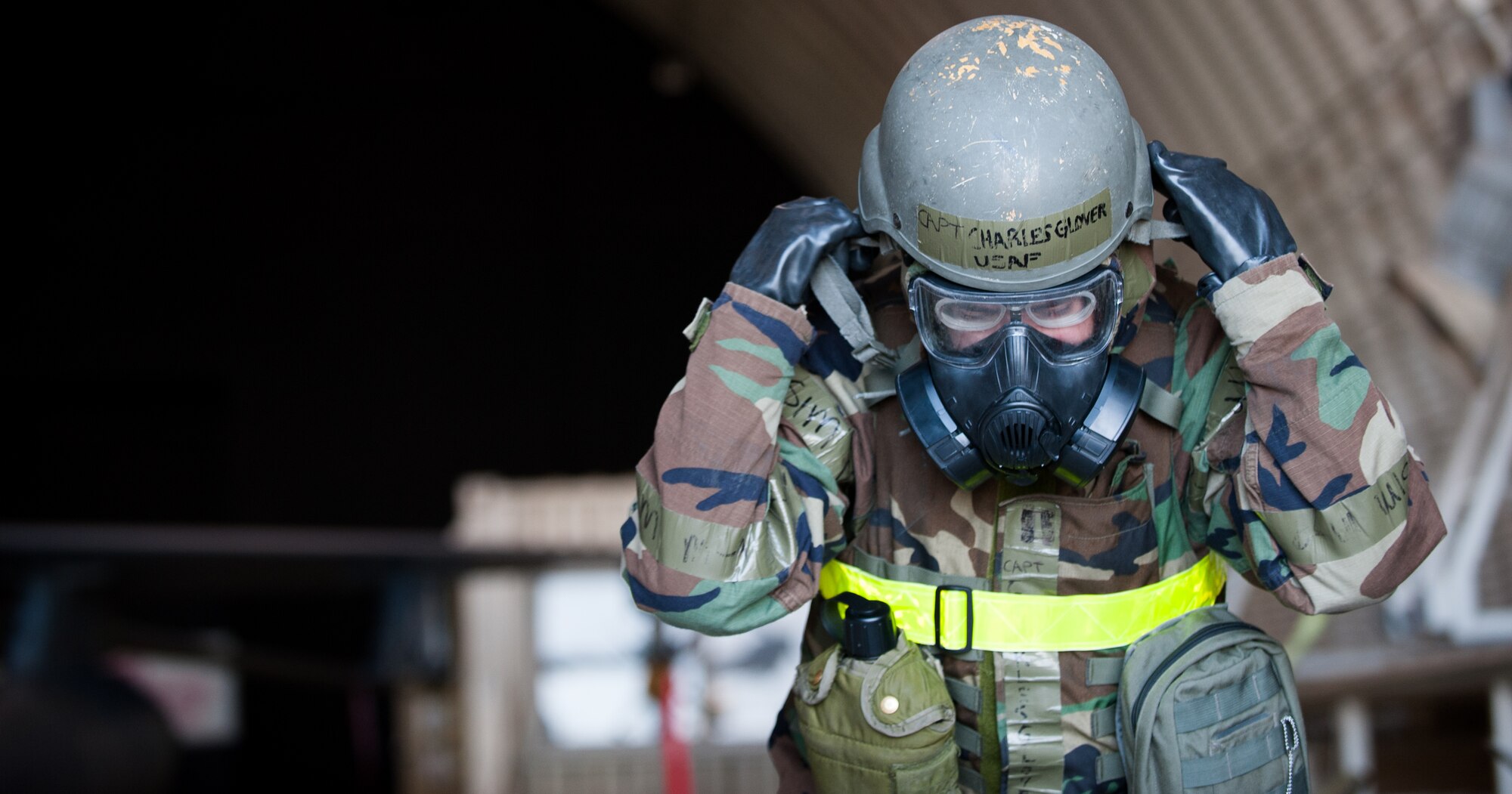 Capt. Charles Glover, 8th Aircraft Maintenance Squadron, tightens his helmet after a simulated chemical missile strike at Kunsan Air Base, Republic of Korea, Nov. 20, 2013. Kunsan’s pilots and maintainers continued to launch F-16 Fighting Falcons, during a simulated chemical environment. The base tested its ability to generate aircraft under simulated hostile field conditions. The Wolf Pack, along with other 7th Air Force units, continued performing its operational and tactical wartime missions during the peninsula-wide exercise Beverly Bulldog 14-01. (U.S. Air Force photo by Senior Airman Armando A. Schwier-Morales)