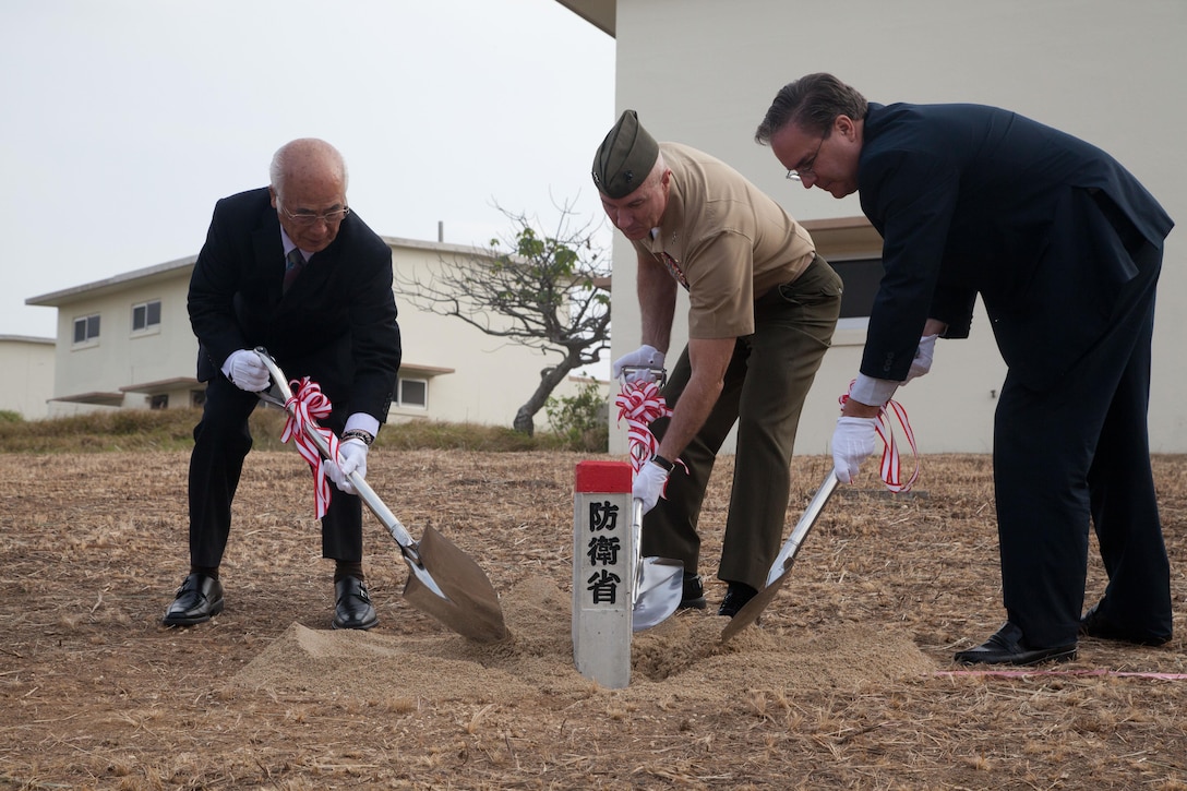 Maj. Gen. Charles L. Hudson, center, U.S. Consul General, Naha, Alfred R. Magleby, right, and the Ginowan Landowners Association President, Shinichi Matayoshi, install a boundary marker Nov. 22 at West Futenma Housing Area on Camp Foster. The marker establishes the new boundary line between the city of Ginowan and Camp Foster signifying the progress made since April 6. Hudson is commanding general of Marine Corps Installations Pacific. (U.S. Marine Corps photo by Lance Cpl. Natalie M. Rostran/ Released)