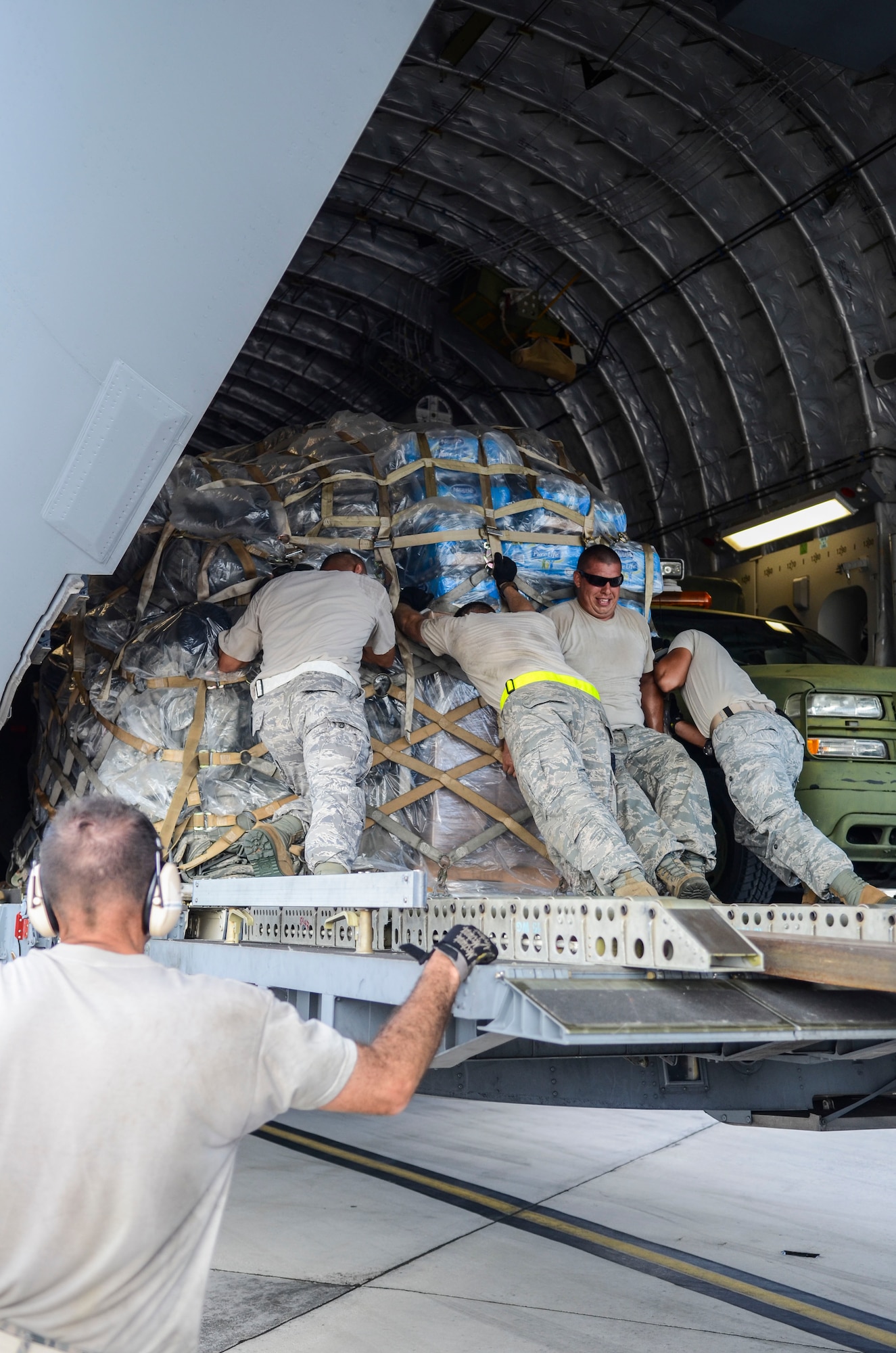 Airmen from the the 36th Contingency Response Group and 734th Air Mobility Squadron move pallets in a C-17 Globemaster III Nov. 15, 2013, on the Andersen Air Force Base, Guam, flightline before the aircraft departs to support Operation Damayan in Tacloban, Philippines. Operation Damayan is a U.S. humanitarian aid and disaster relief effort to support the Philippines in the wake of the devastating effects of Typhoon Haiyan. 
