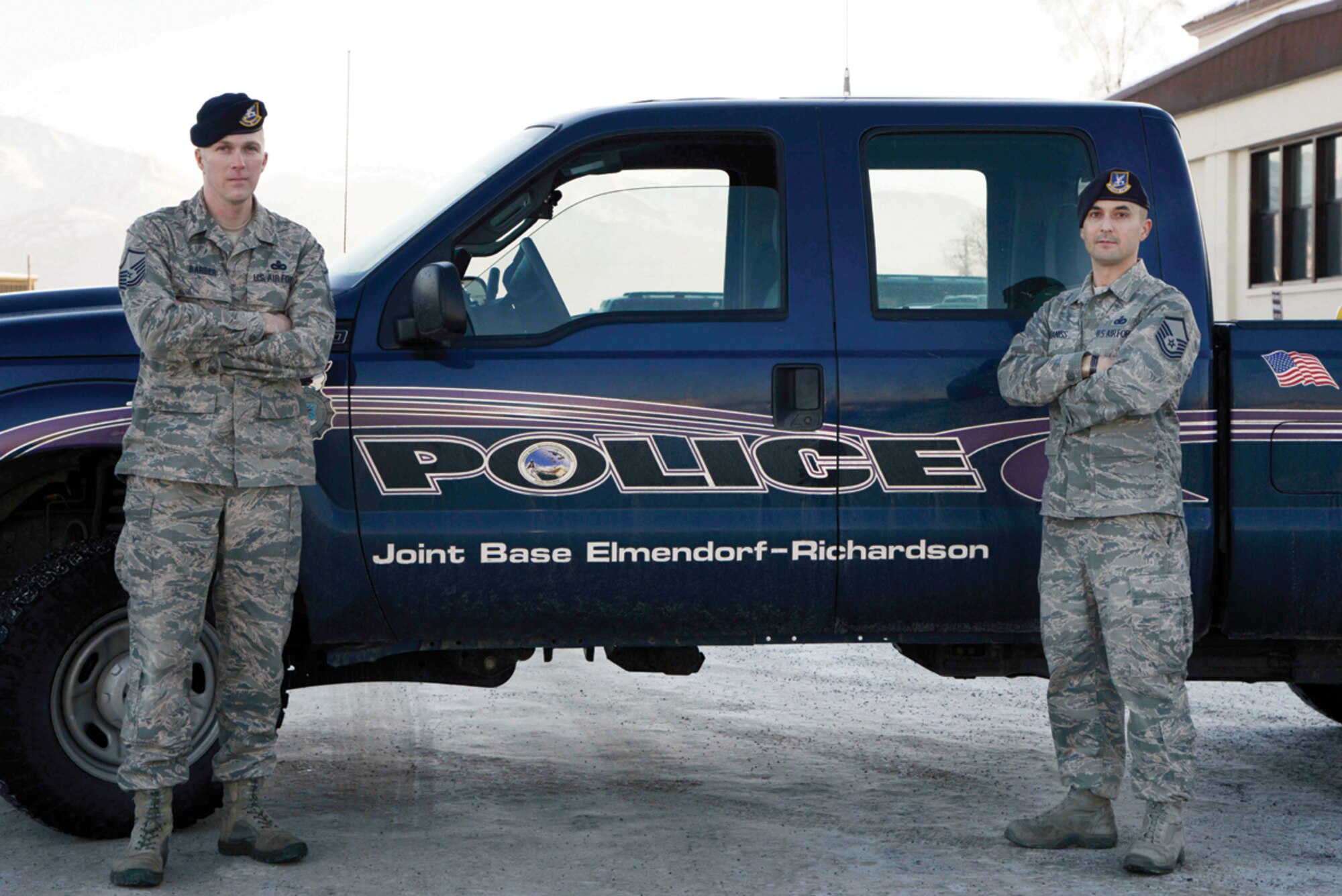 (Left to right) Master sergeants David Barber and Morgan Cabaniss, 673 Security Forces Squadron, pose for the camera on Joint Base Elmendorf-Richardson, Alaska, Nov. 18, 2013. Barber and Cabaniss rescued a wrecked trucker 100 miles north of Arctic Circle braving -35 degree windchill and subzero temperature. (U.S. Air Force photo/Staff Sgt. Sheila deVera)
