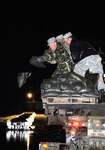 North Dakota National Guard Soldiers drop sandbags into the water that is overflowing Ward County Road 14 near Minot, N.D. The Soldiers are on state active duty fighting the rising waters in Ward County courtesy of the record snowfall that was received this winter in North Dakota.