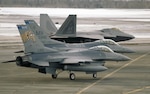 Two F-16C Fighting Falcons of the 148th Fighter Wing, Duluth, Minn. prepare for take off next to an F22 Raptor on March 3rd, 2008 during a recent deployment to Elmendorf AFB, Alaska. While deployed, the 148th was the first non-Alaskan or Canadian unit to support Alaska Command (ANR) alert and the first F-16 unit to intercept Russian bombers, also knows as "Bears".