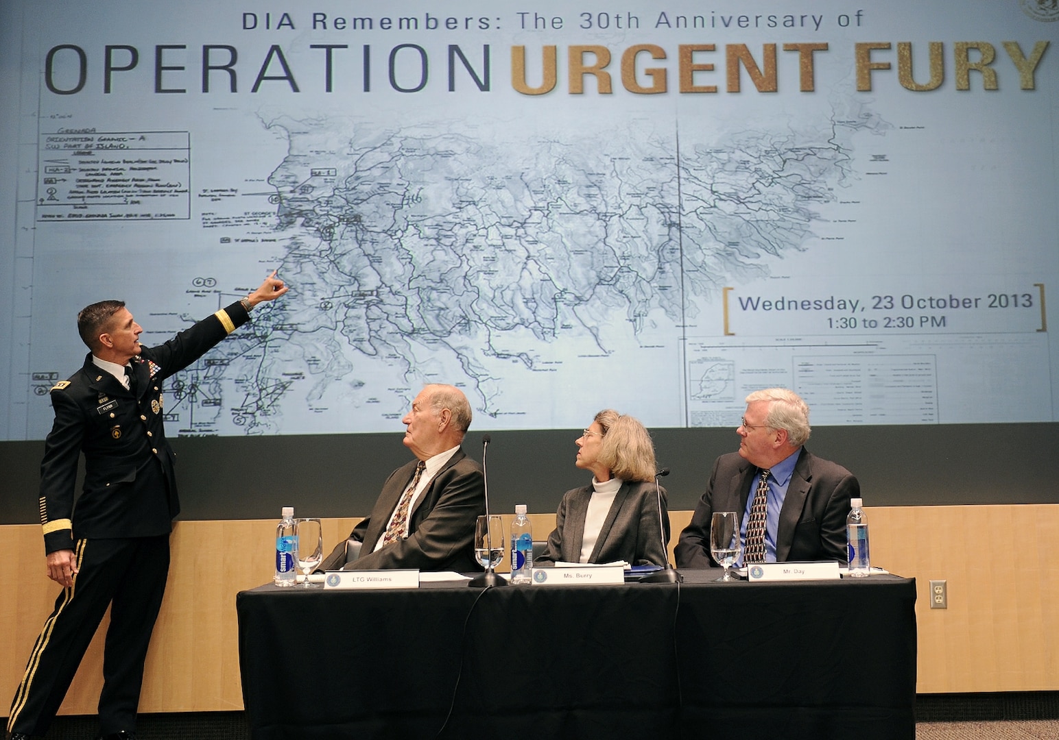 DIA Director LTG Michael Flynn annotates key positions on a map while sharing his experience and role in Operation Urgent Fury during the 30-year anniversary commemoration event Oct. 23.