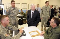 Defense Secretary Robert M. Gates talks with initial flight students and their instructors on Cairns Army Airfield, Ala., April 14, 2009, during a two-day trip to Alabama.