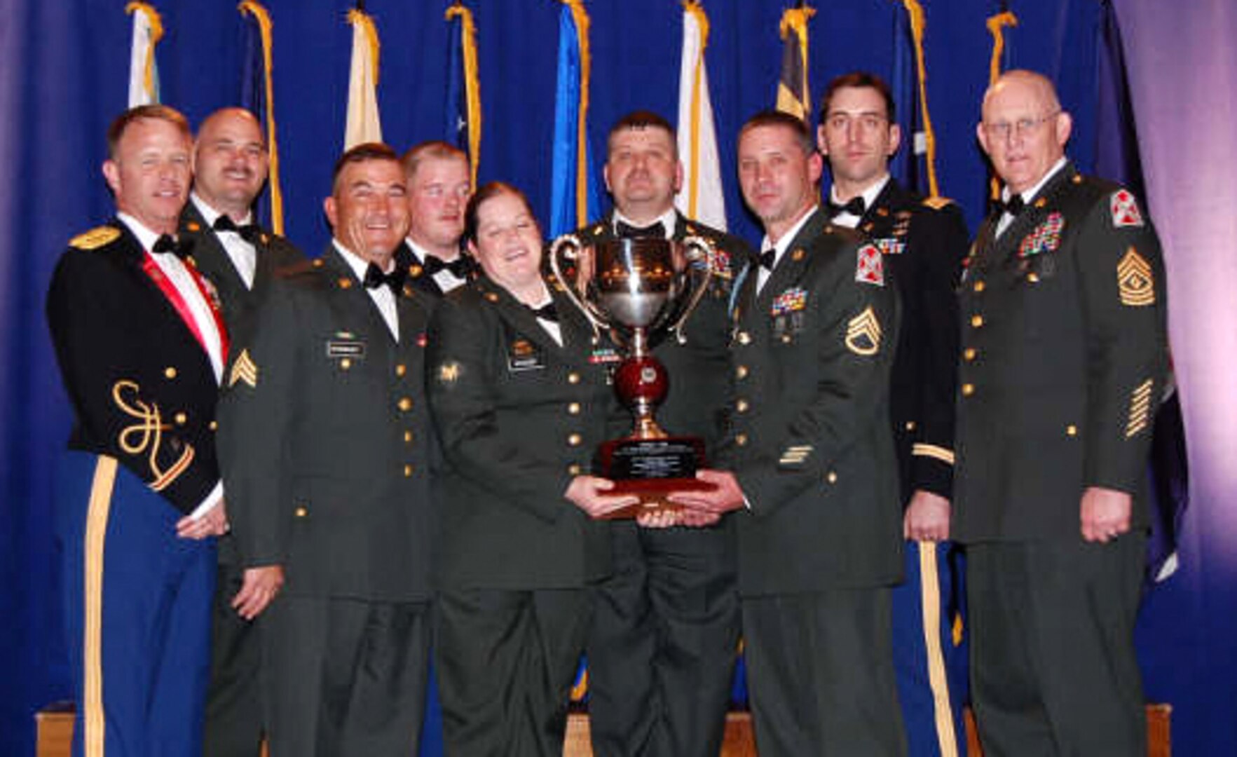 Members of the Virginia National Guard pose with the 2008 Connelly Award April 2 in Atlanta. The 1032nd Transportation Company was awarded the Connelly Award for excellence in Army Food Service in the National Guard Field Kitchen Category for 2008. Members of the unit who attended the awards ceremony include: 1st Sgt. E. Tim Miller - Staff Sgt. Allen Osburn, Staff Sgt. Ralph Norris, Sgt. Vincent Woodmancy, Sgt. Paul Woodmancy, Spc. Julie Woodby, Spc. Gary Martin, Spc. Brandon Sexton and Spc. Billy Rose.