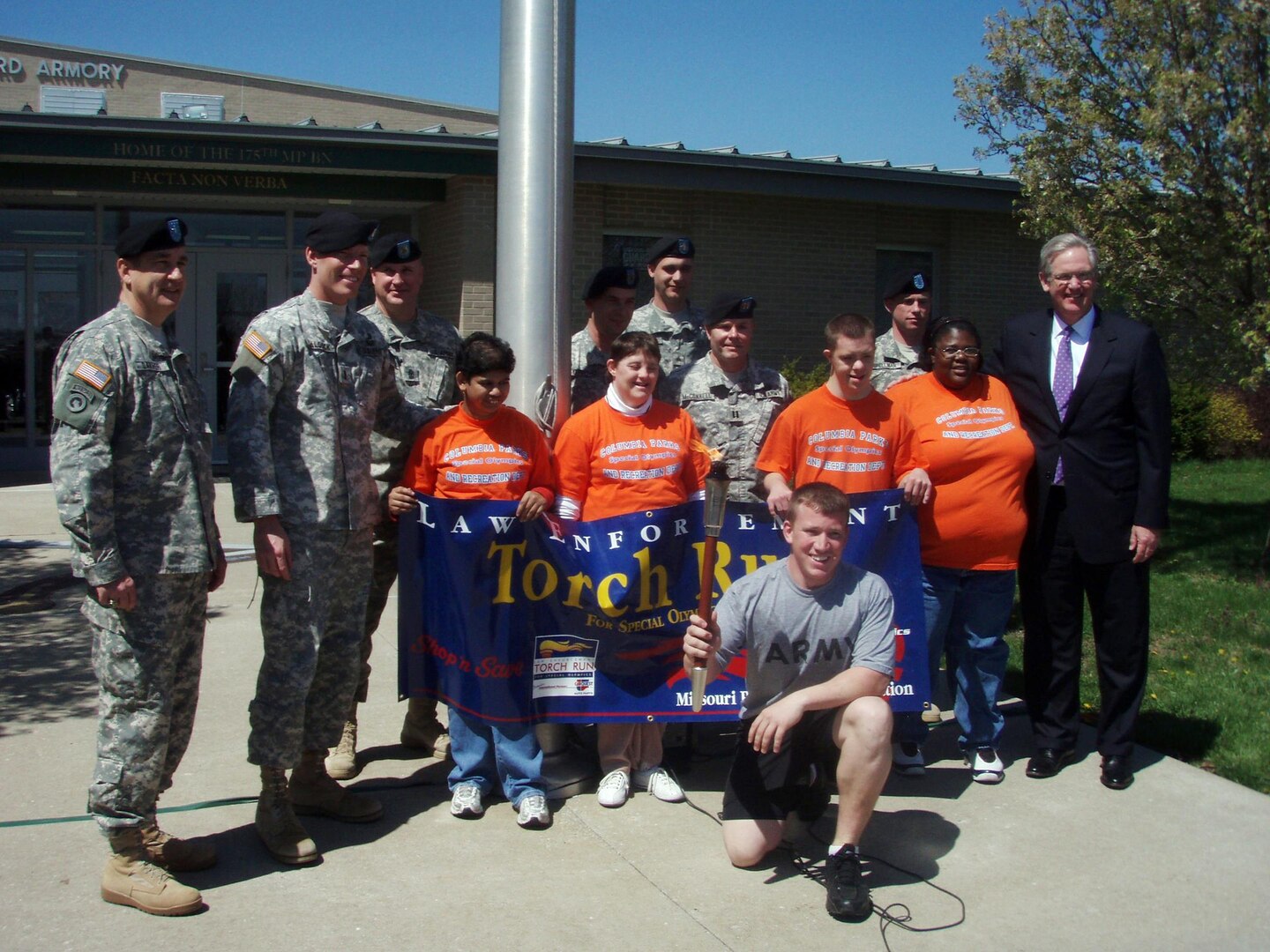 Soldiers of the Missouri National Guard's 175th Military Police Battalion with Brig. Gen. Stephen L. Danner (far left), Gov. Jay Nixon (far right) and athletes of the Special Olympics Missouri.