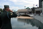 A soldier from the 29th Infantry Division overlooks the newly-dedicated National D-Day Memorial as he renders a salute during the playing of "Taps."