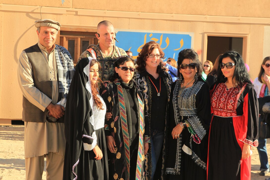 Col. Andrew Kennedy, director, Tactical Training Exercise Control Group, stands with Afghan roleplayers during the Tactical Training Exercise Control Group's "A Day in the Life" event at Range 215 Nov. 17, 2013.


