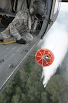 North Carolina Army National Guard SGT Joseph Elmorel, a crew chief, looks out of a UH-60 Blackhawk while the aircraft drops water using a "Bambi Bucket" onto fires nearby Myrtle Beach, South Carolina. Four UH-60 Blackhawk Helicopters and crews from the North Carolina Army National Guard's Company C, 1st Aviation Assault Battalion, 131st Aviation Regiment based in Salisbury, N.C. have been deployed to help extinguish the wildfires.