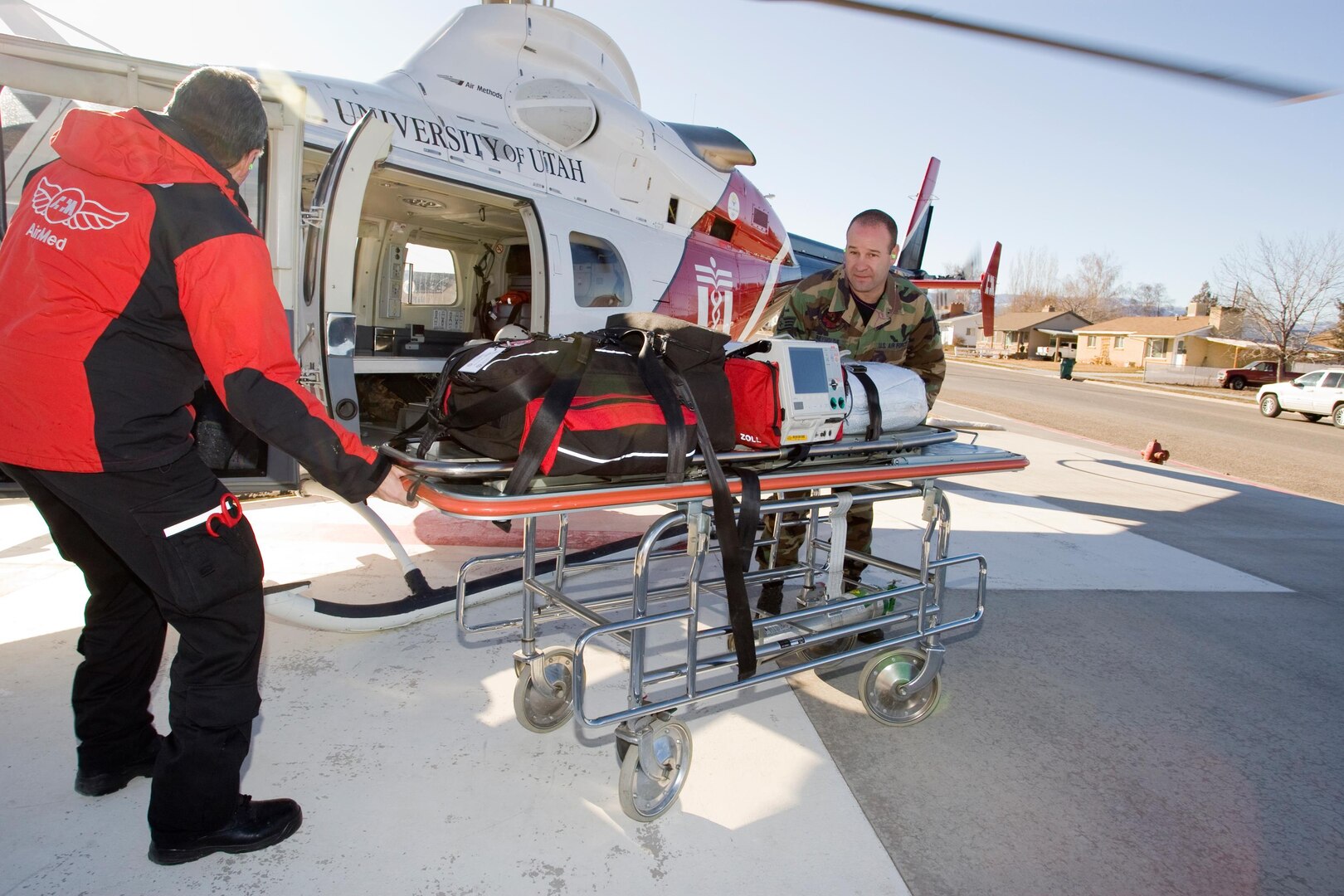 Staff Sgt. Alan Reynolds of the 151st Medical Group of the Utah Air National Guard helps air paramedic Tom Robertson unload equipment from a Bell 430 AirMed helicopter into the Vernal, Utah hospital. Sergeant Reynolds is one of 19 Utah Air Guard medics, who are participating in a special ride-along program with the University of Utah AirMed unit.