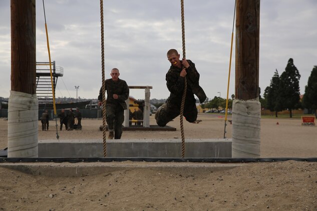 Recruits run and jump latching on to a rope to swing across the Run Jump Swing during the confidence course aboard the depot, Nov. 4. Recruits were divided into groups and led around the course by a different drill instructor. 