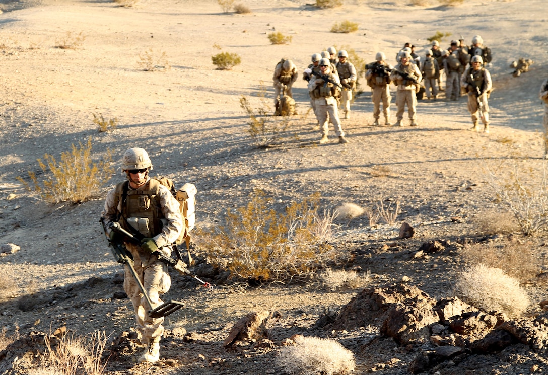 A Marines with 81mm mortars platoon, Weapons Company, 3rd Battalion, 5th Marine Regiment, searches formprovised-explosive devices during a partol while conducting a counter-IED exercise at Range 215, Nov. 15, 2013.
