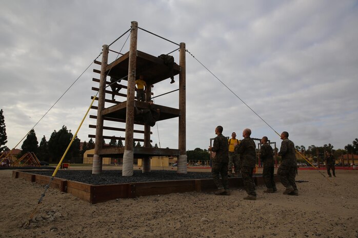 Company G recruits climb the three story Skyscraper during the confidence course aboard the depot, Nov. 4. Before recruits start the course, drill instructors guide the recruits around each obstacle and demonstrate how each station works using the proper technique.