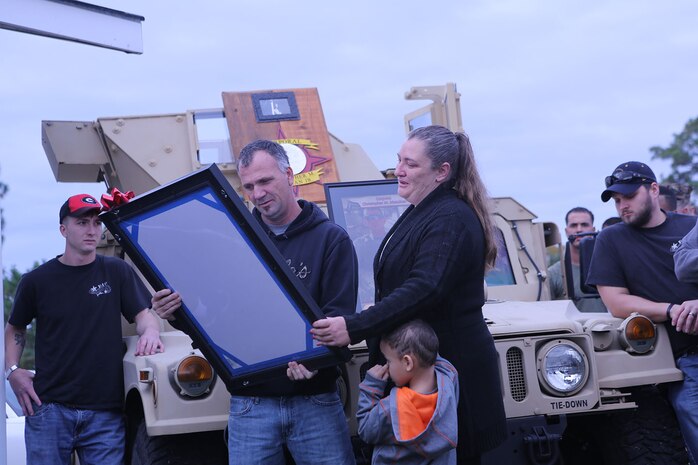 The family of Cpl. Christopher M. Monahan Jr. is presented a hand drawn picture to commemorate their service and sacrifice during a memorial 5k at a park aboard Camp Lejeune, N.C., Nov. 22, 2013. Marines with Transportation and Support Company, Combat Logistics Battalion 2, 2nd Marine Logistics Group gathered to run a 5k and enjoy a cookout to remember two fallen Marines. 