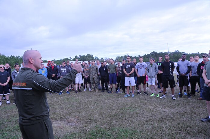 Capt. Lee Stuckey, the commanding officer of Transportation and Support Company, Combat Logistics Battalion 2, 2nd Marine Logistics Group, speaks to the Marines before a memorial 5k at a park aboard Camp Lejeune, N.C., Nov. 22, 2013. Marines that served with Cpl. Christopher M. Monahan Jr. and Lance Cpl. Dale W. Means, who were killed in action, shared their life experiences with everyone, wanting to remind everyone what kind of people they were.