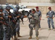 Staff Sgt. Michelle Smith of Henrico, Va., watches to make sure that the training being taught is well received after every demonstration. Members of the 266th assisted Al Hartha police officers by conducting weapons training and movement techniques.