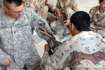Louisiana Army National Guardsman Staff Sgt. Adam Sanchez of Pineville, La., has a member of the 11th Iraqi Army Engineer Regiment apply an improvised tourniquet during first aid training on May 13. Combat medics from the 225th Engineer Brigade of Pineville, La., taught members of the 11th Iraqi Army Engineer Regiment life-saving skills to include basic first aid, litter carry procedures, dressing a wound and how to apply a tourniquet.