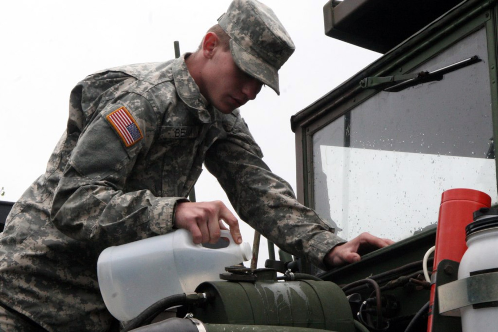 Private Justin Bean of Tazewell adds water to the coolant system of a 5-ton dump truck May 17 in preparation for a convoy movement to West Virginia. The Virginia National Guard's 1033rd Engineer Company based in Cedar Bluff, Va., departed May 18 to assist with debris removal and flood recovery in West Virginia. The unit is scheduled to be on duty for up to 30 days.